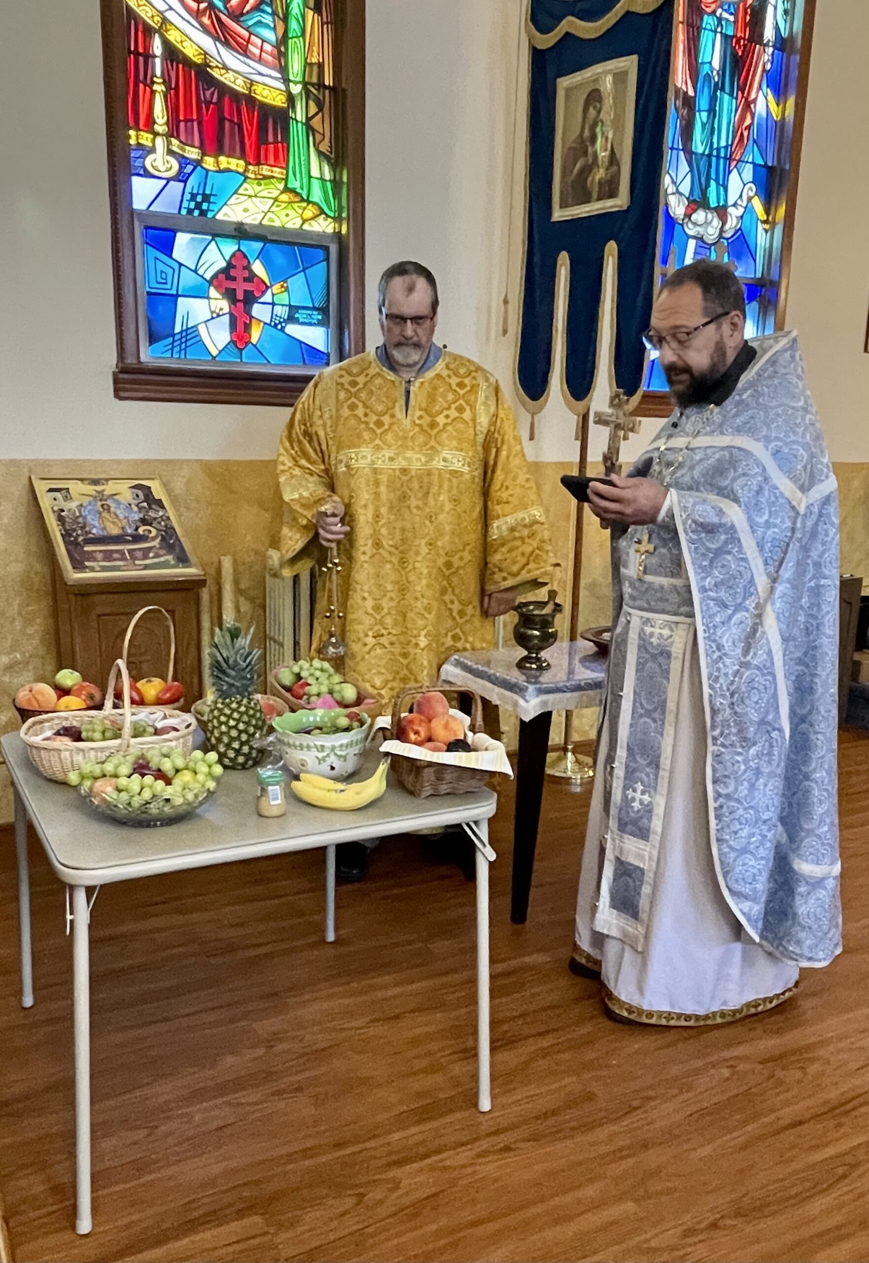Orthodox priest Fr. Joseph blessing the fruits.