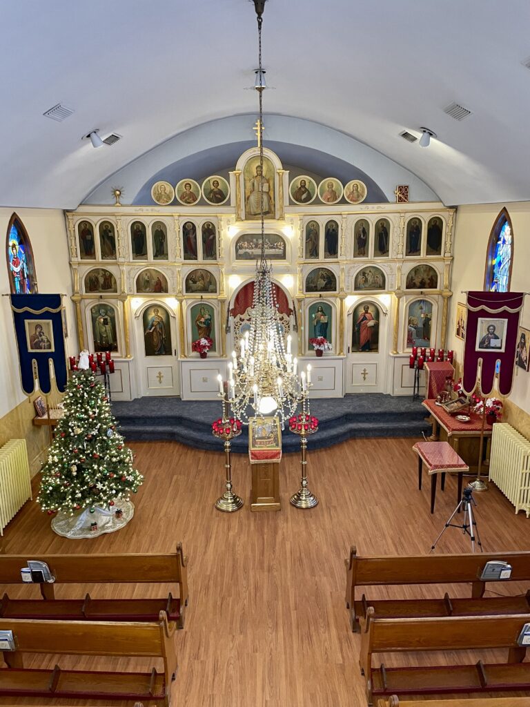 View of St. Mary's Orthodox Church from the choir loft displaying the Christmas vestments, candles, icons, and decorations.