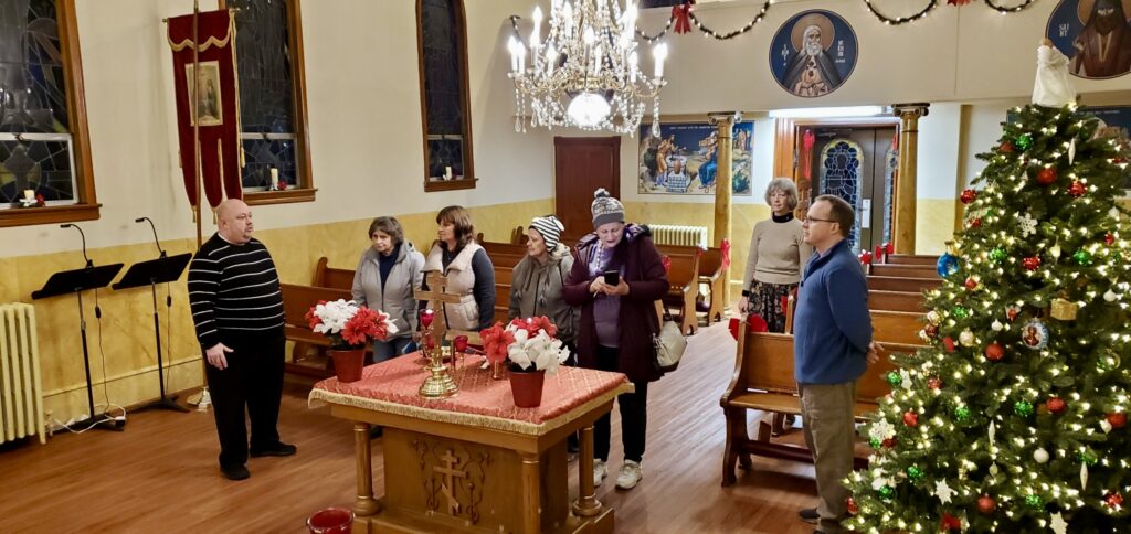 Visitors tour an Orthodox church at Christmastime.